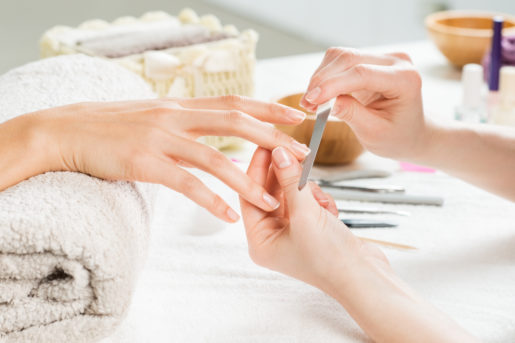 Woman enjoying a manicure in a health club spa