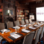 The Library meeting room, grand wood panelled library room set up for a board room style meeting