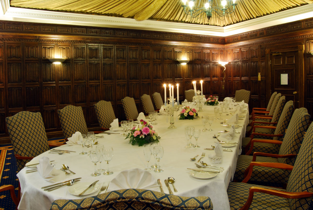 The Oak Room at Mercure York Fairfield Manor Hotel, original oak panelling and draped tented ceiling, chandelier, set up for a meeting