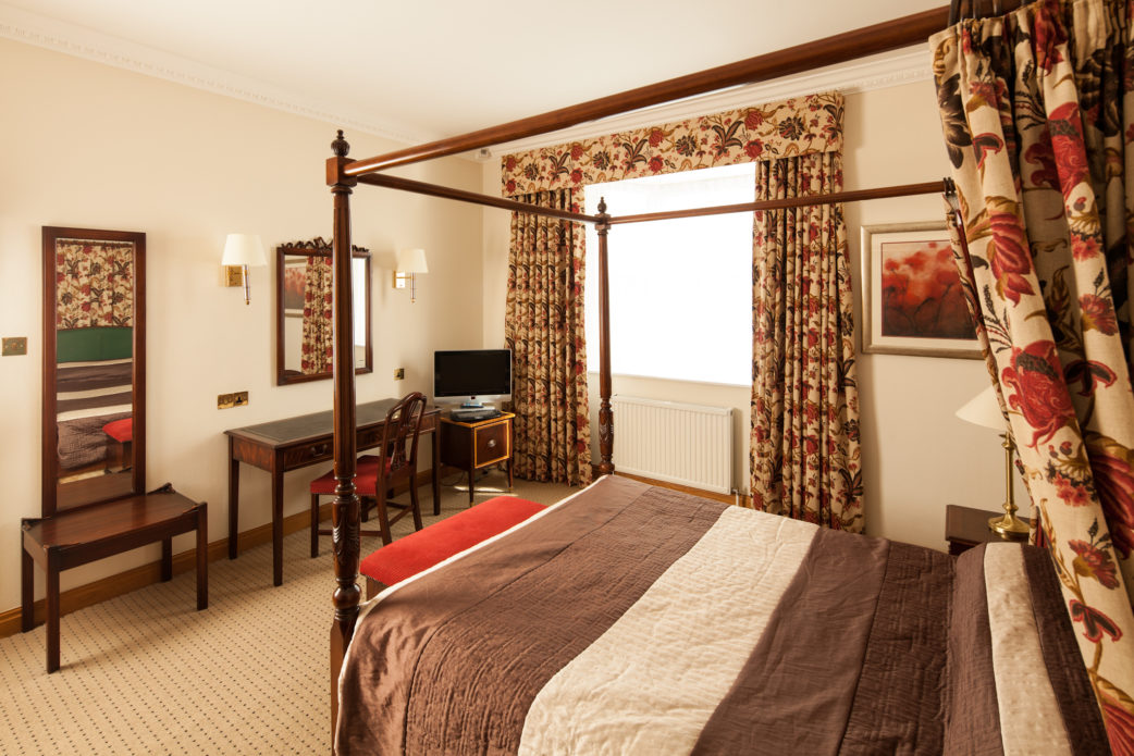 mercure-york-fairfield-manor-hotel-superior-room-04-lr-170412 Superior bedroom at Mercure York Fairfield Manor Hotel, large four poster bed, desk, tv, mirror
