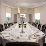 Large dining table in The Congress Room at mercure gloucester bowden hall hotel with place settings for lunch or dinner for 18 people